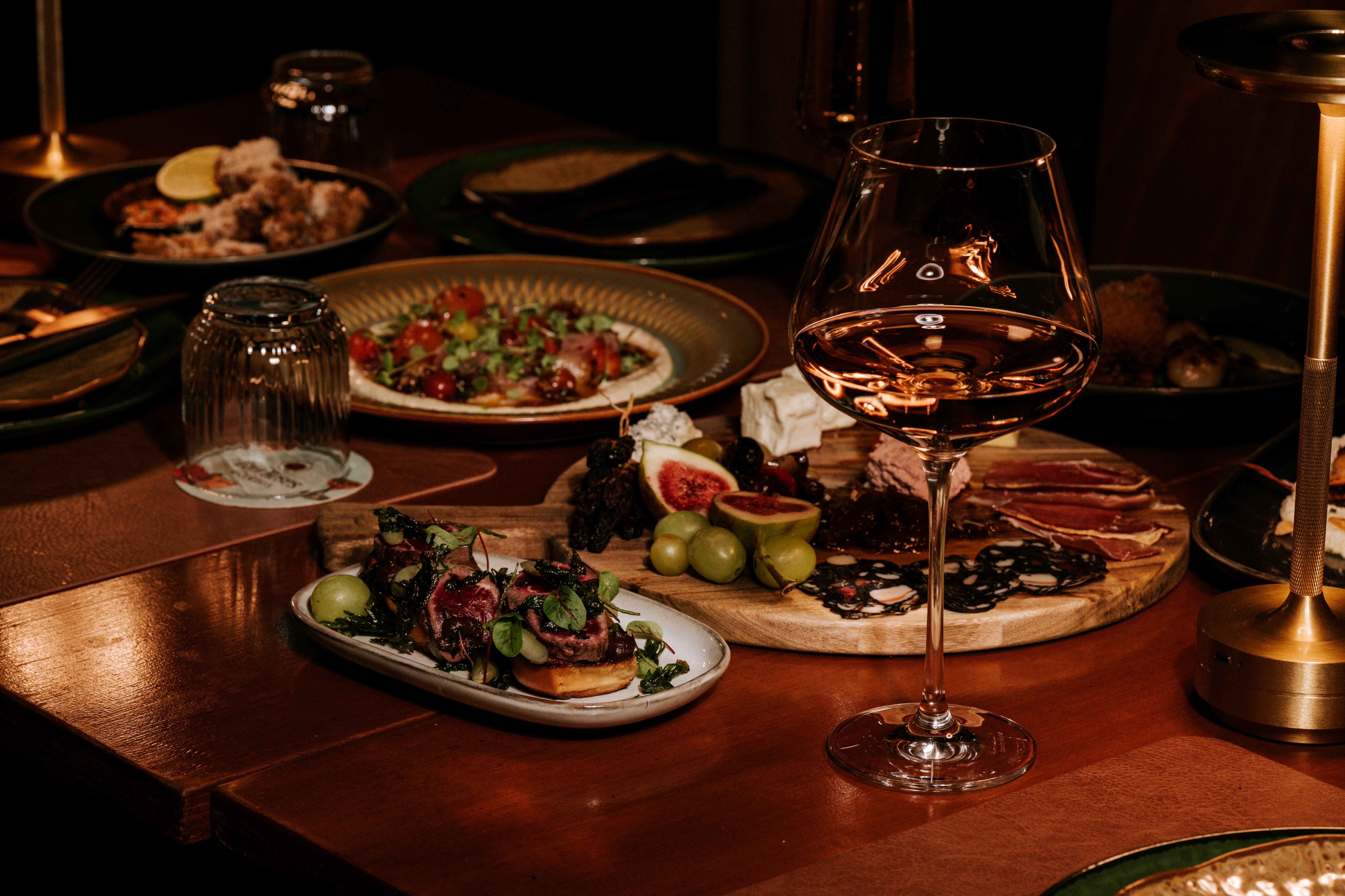 Aranya Acres table spread — native Australian dishes, charcuterie board and wine
