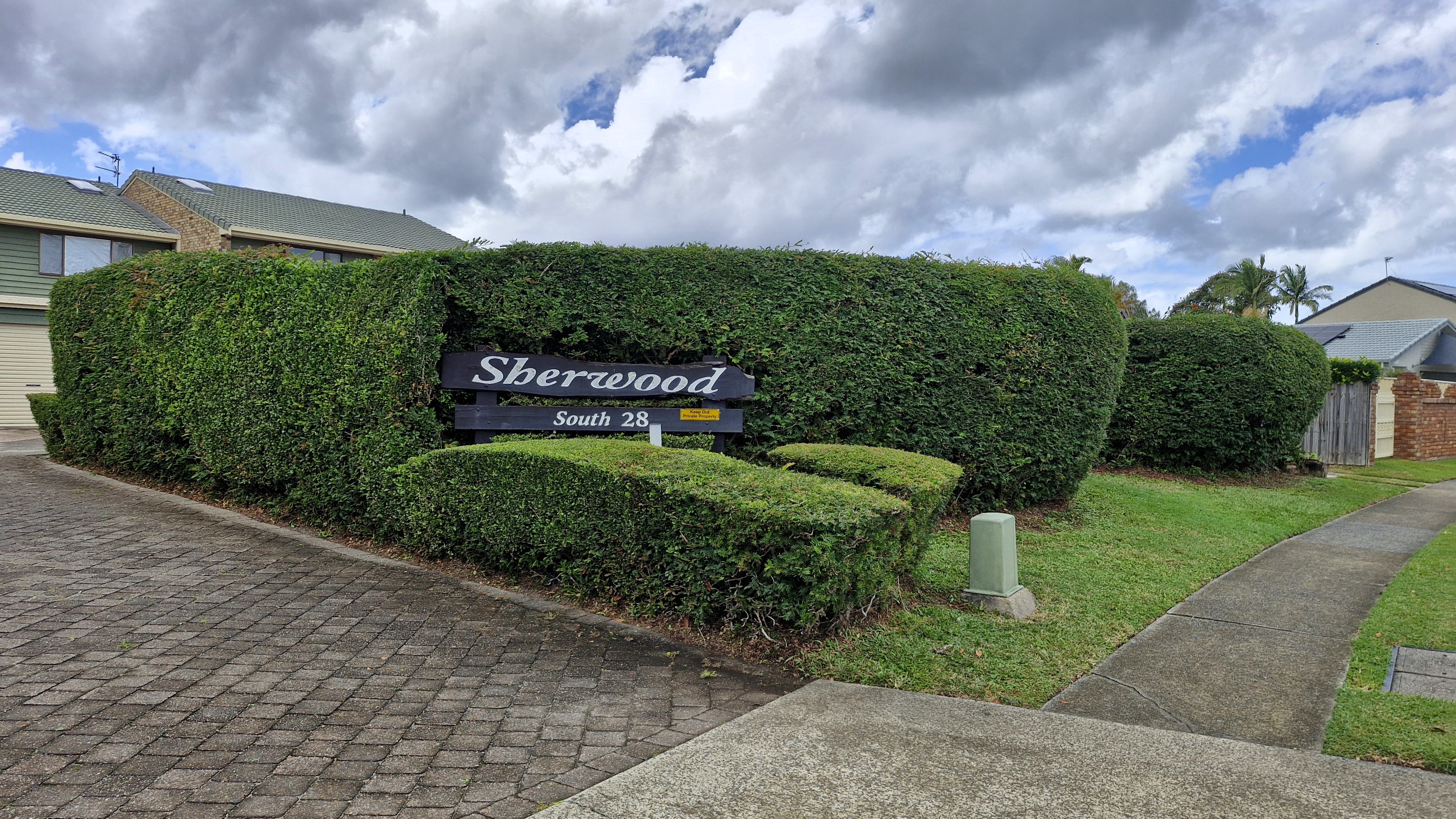 Sherwood South 28 entrance hedge neatly shaped and maintained