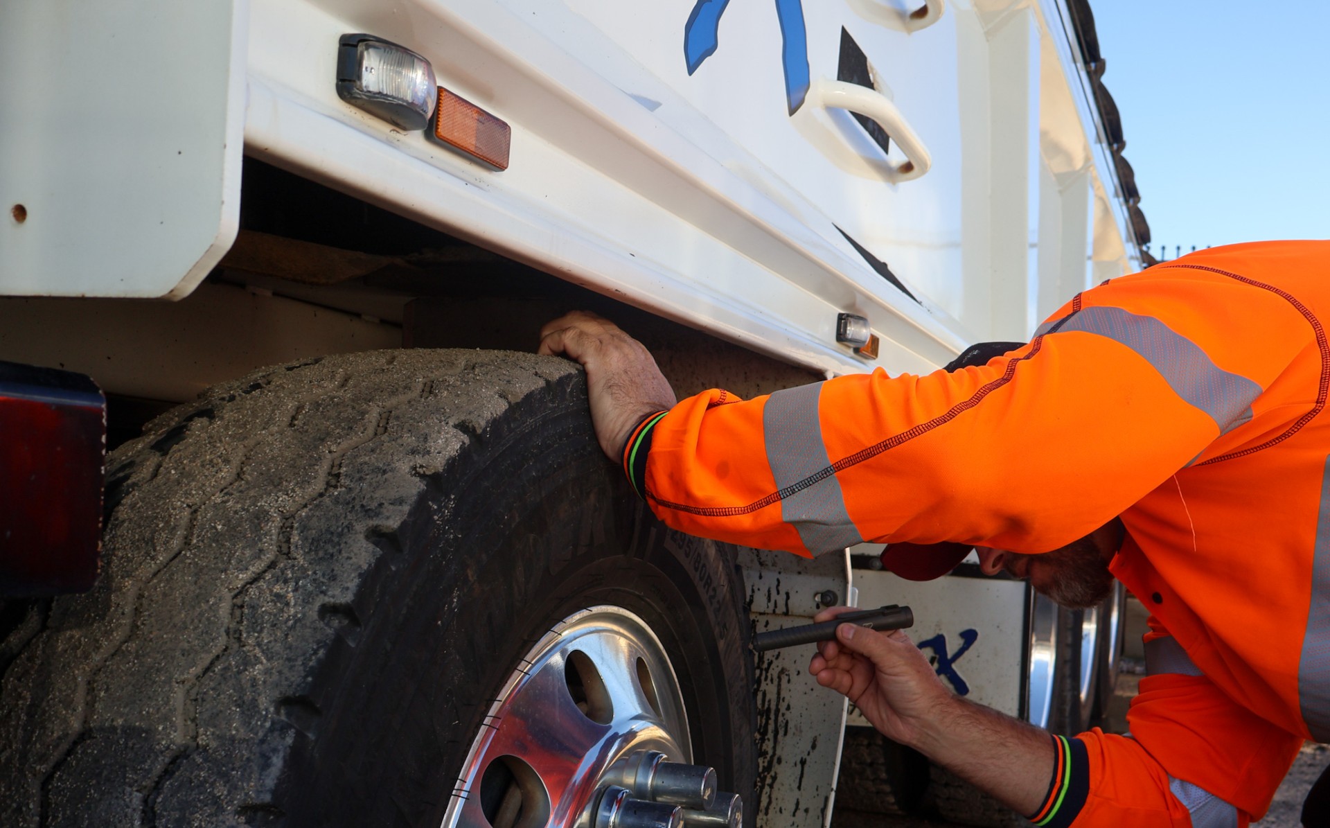 Safety Certificate Centre inspector checking truck tyre on-site