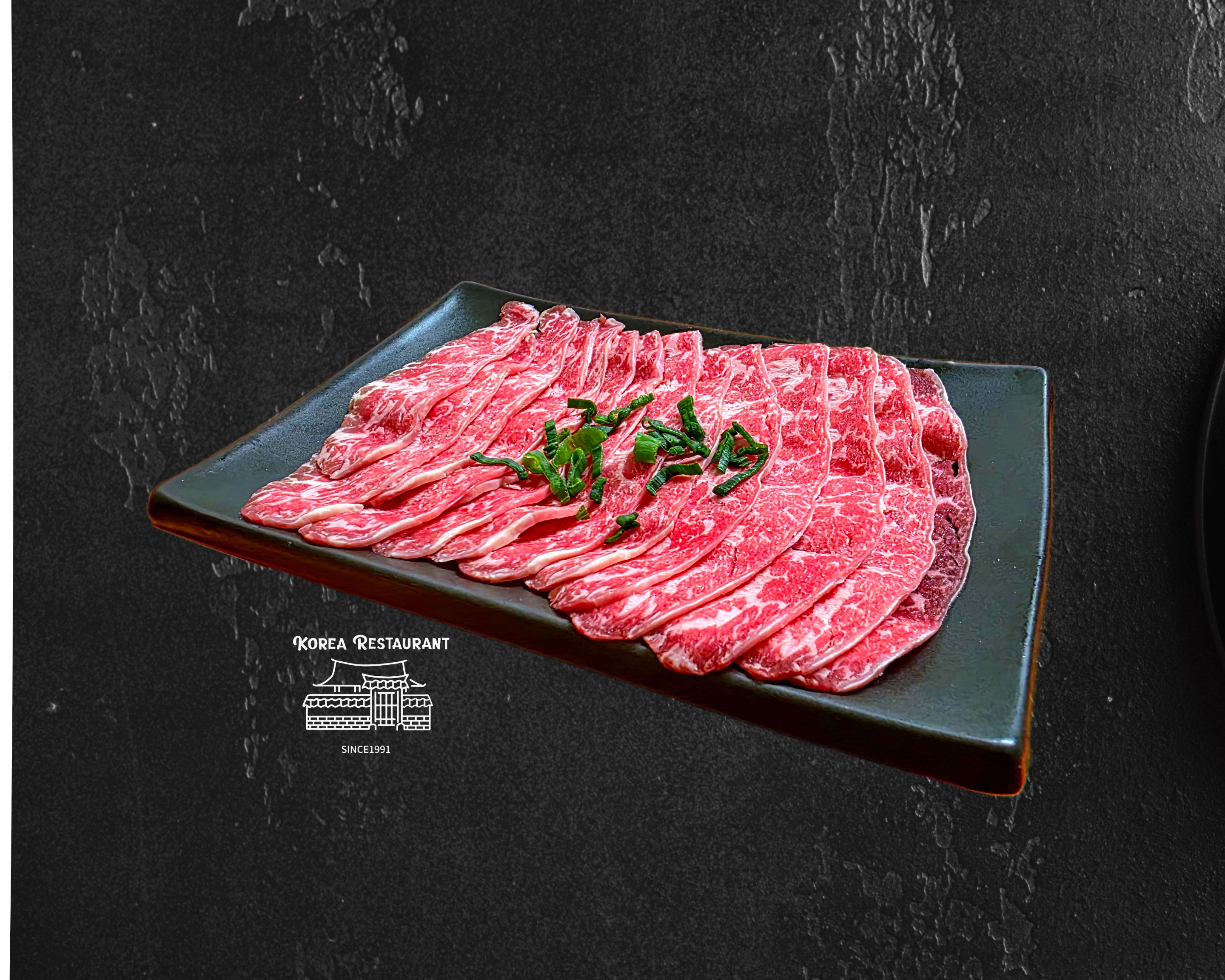 Premium Angus oyster blade thinly sliced on a dark plate