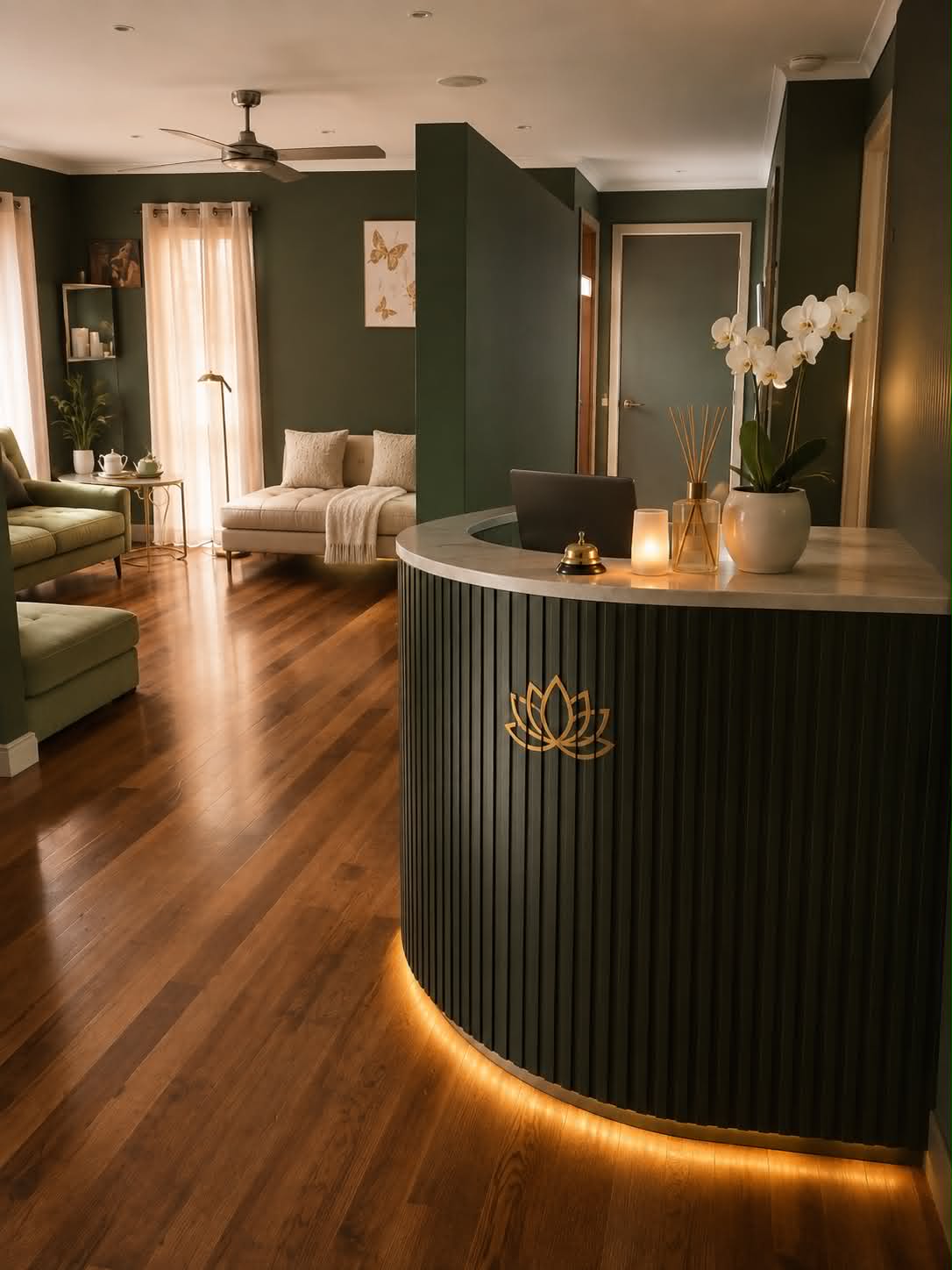 Realuxe Wellness reception desk with lotus emblem, orchid and warm golden lighting
