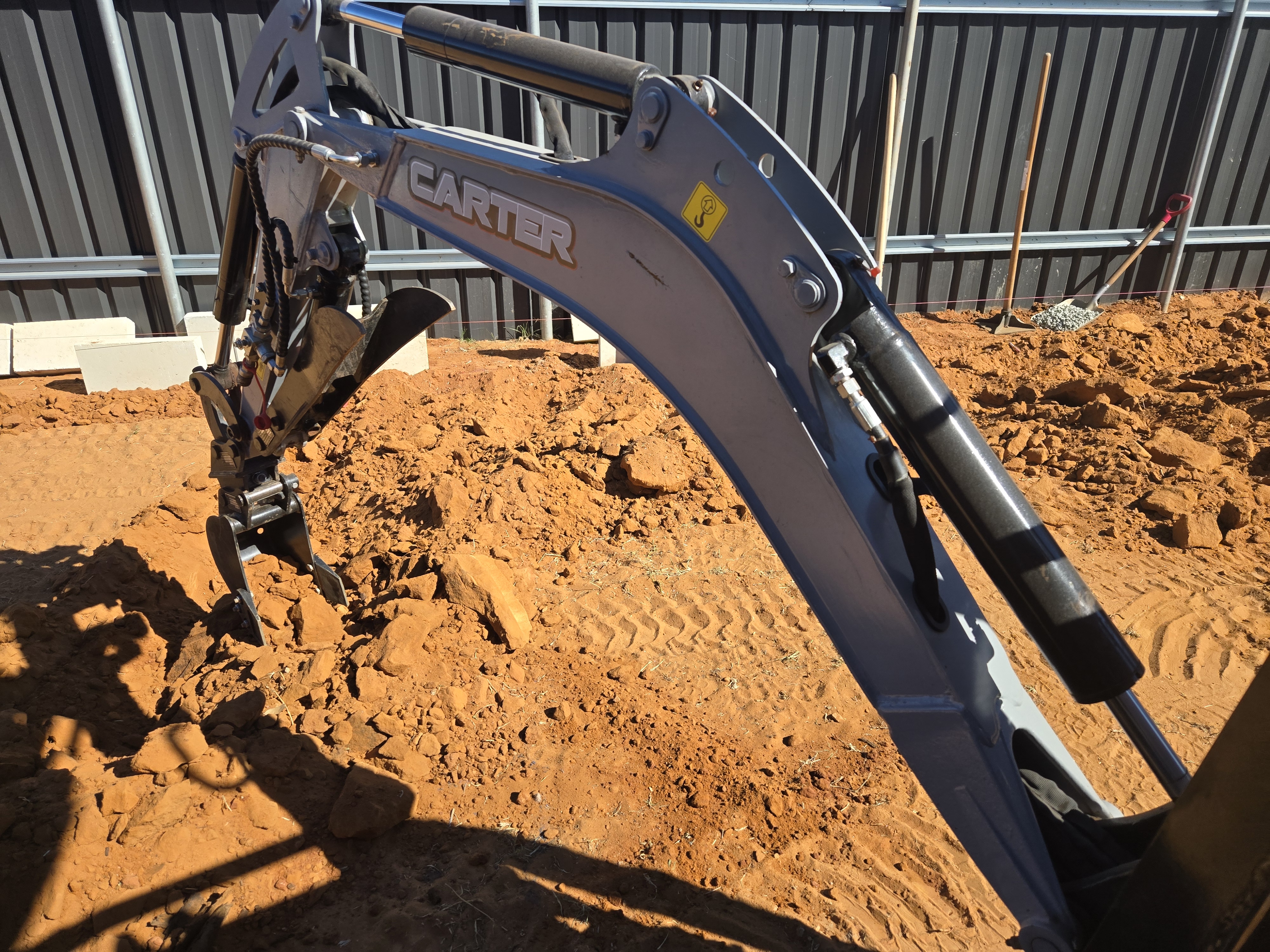 Recent landscaping job in Kalgoorlie: Carter excavator digging site with Colourbond fencing