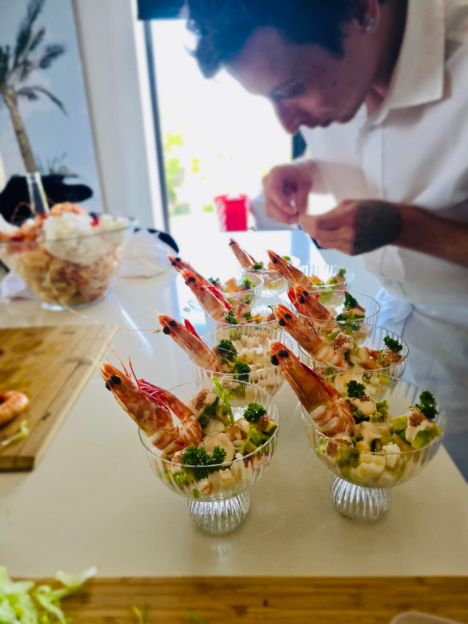 Cormac plating prawn cocktails in glasses