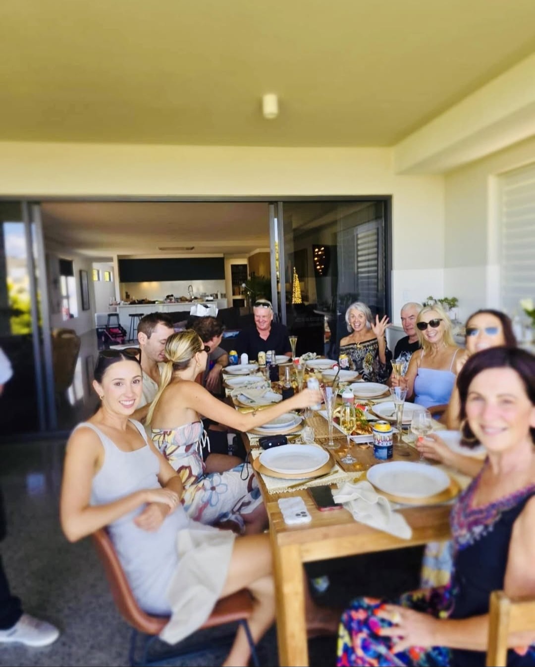 Guests enjoying outdoor dinner party at sunset