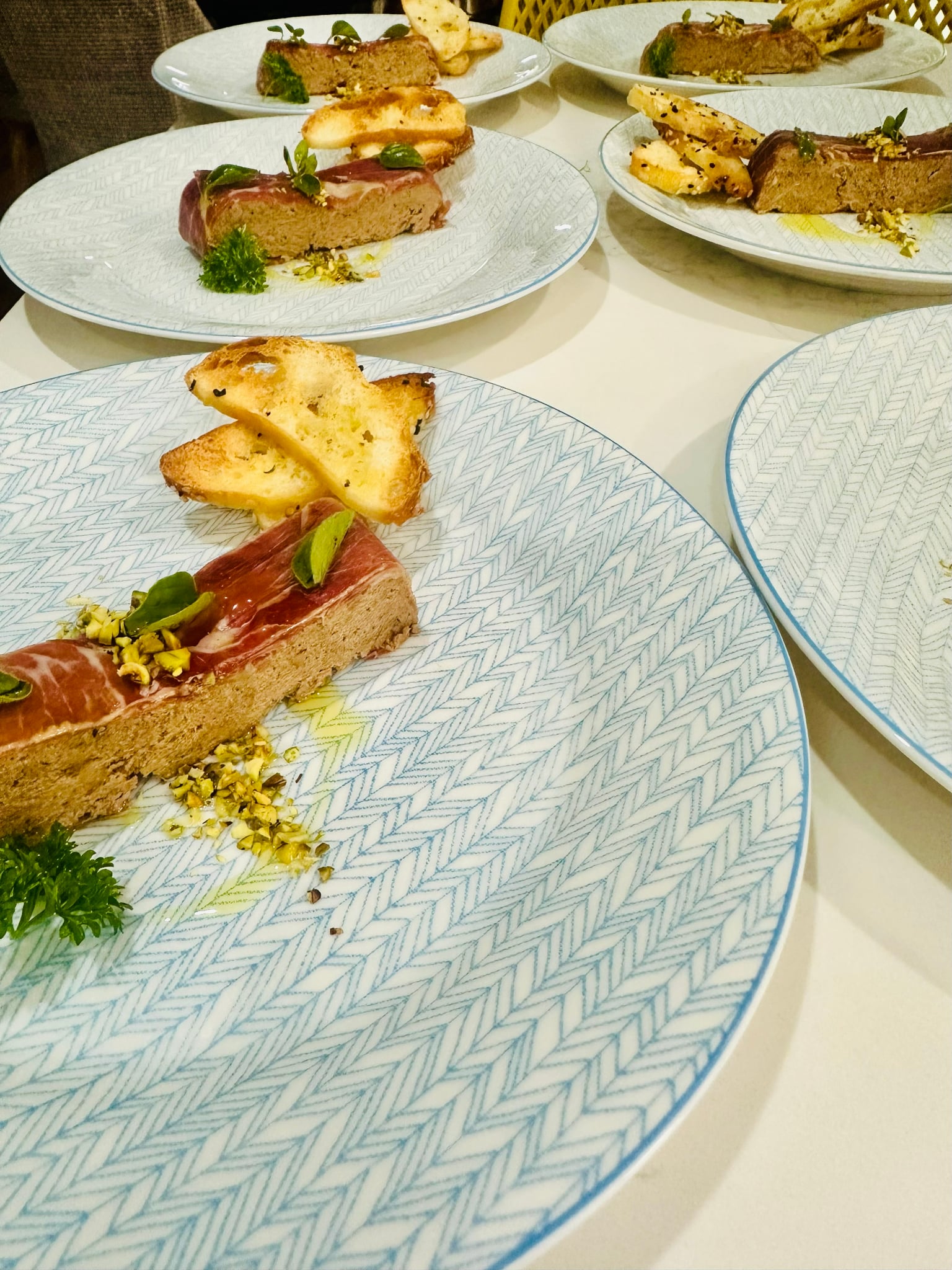 Pâté with prosciutto, pistachios and crostini