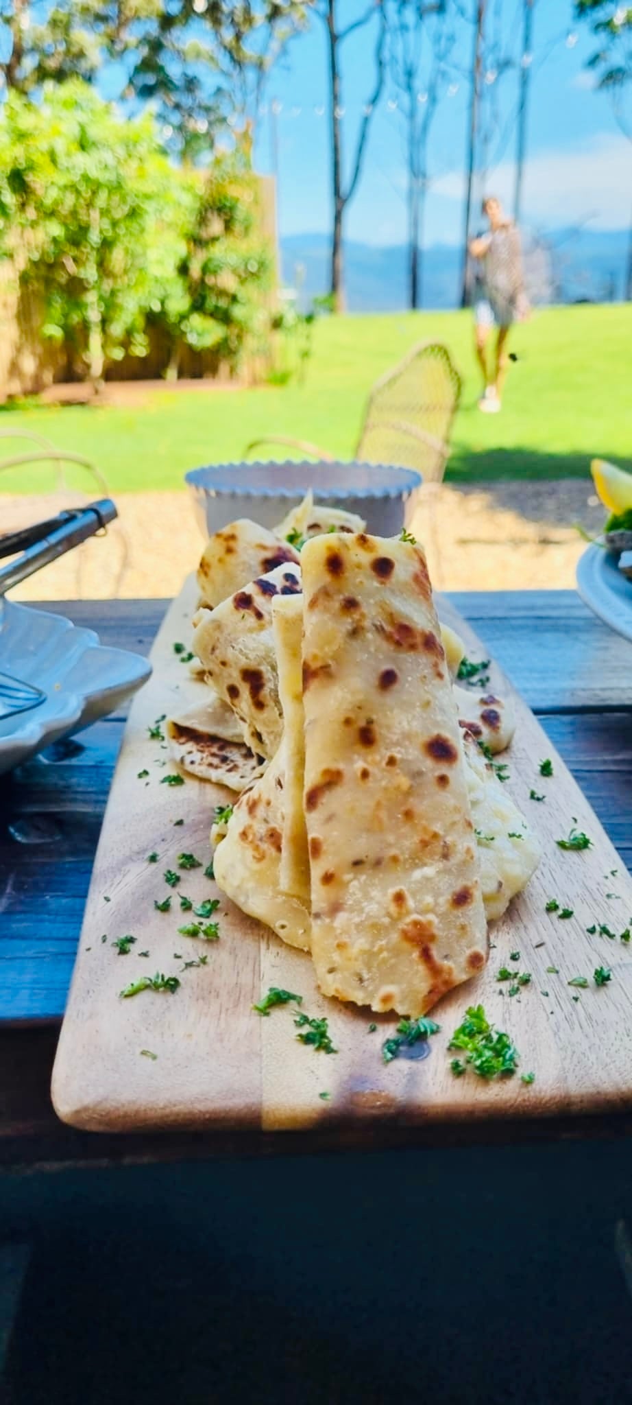 Fresh flatbread on board with hinterland backdrop
