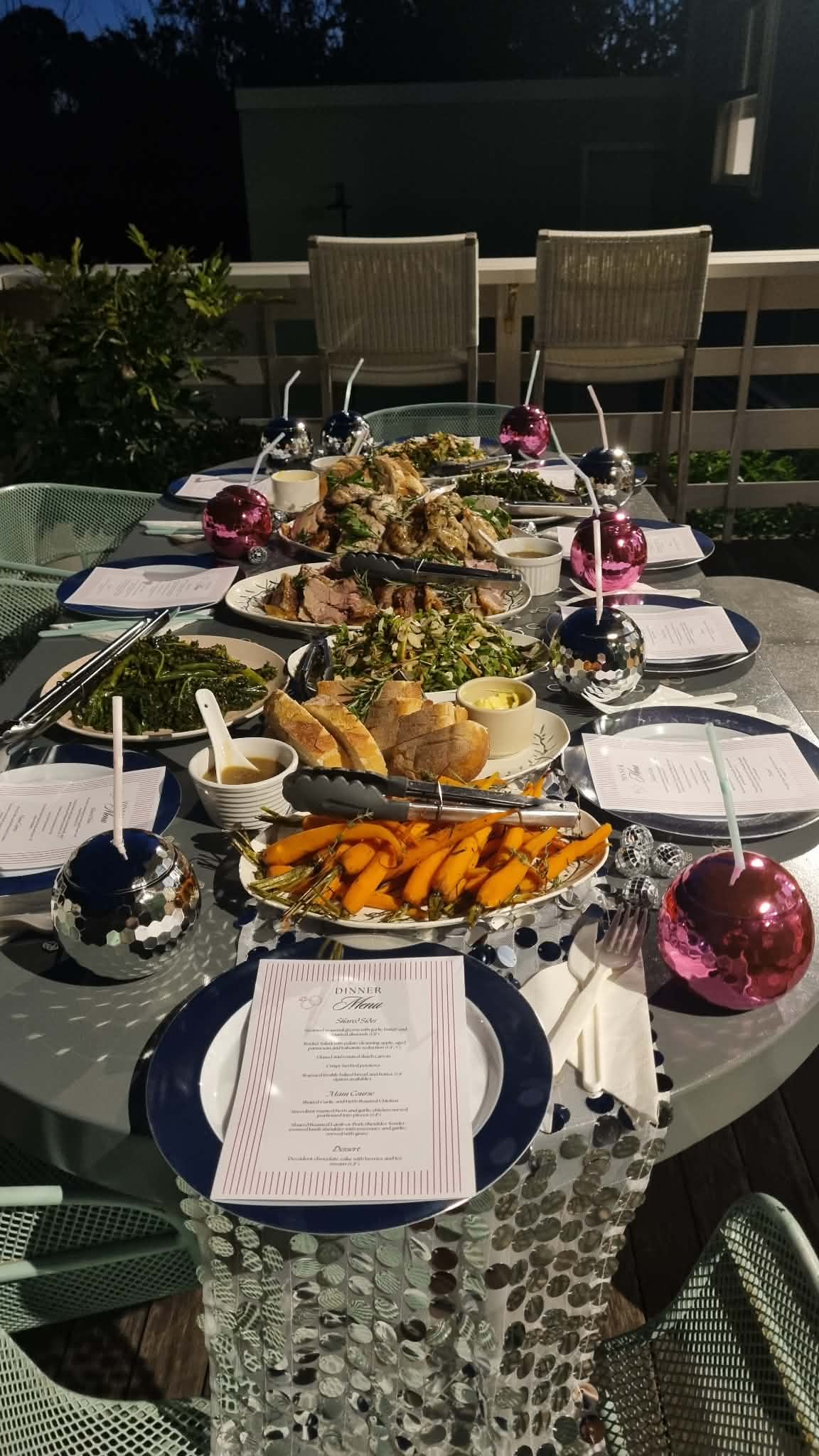 Styled outdoor dinner table with menu cards and festive decorations