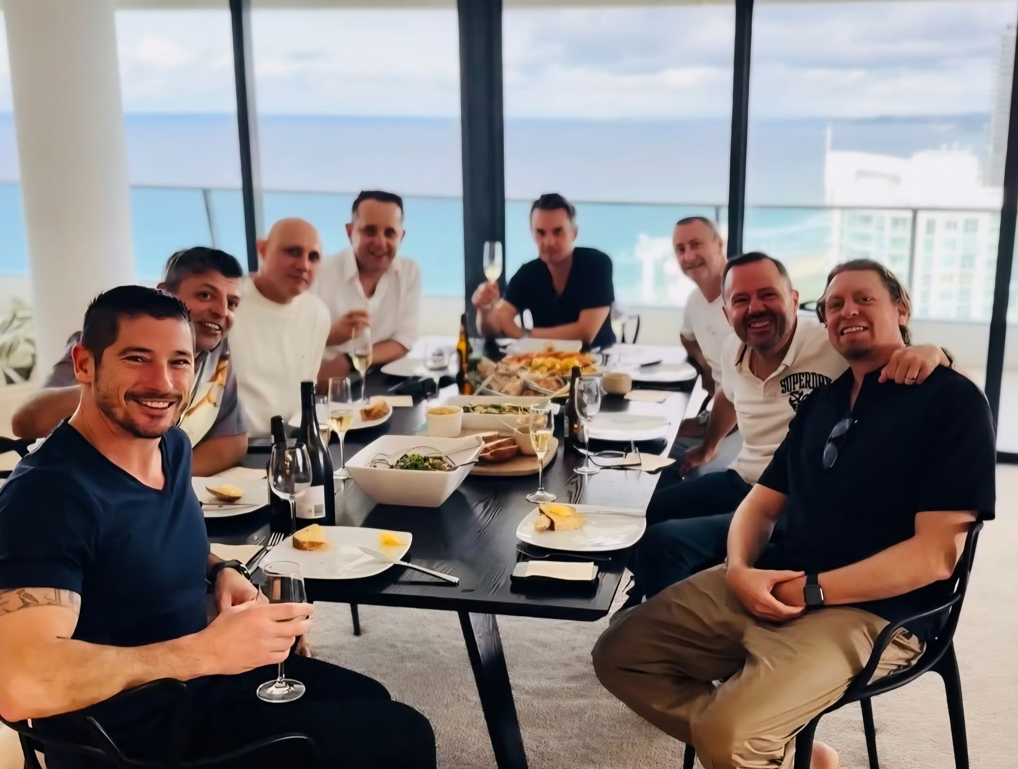 Happy guests at a private dining experience with ocean views