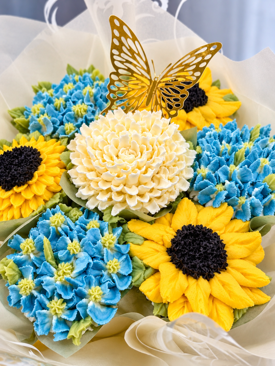 Flower cupcake bouquet with sunflowers, hydrangeas and butterfly topper