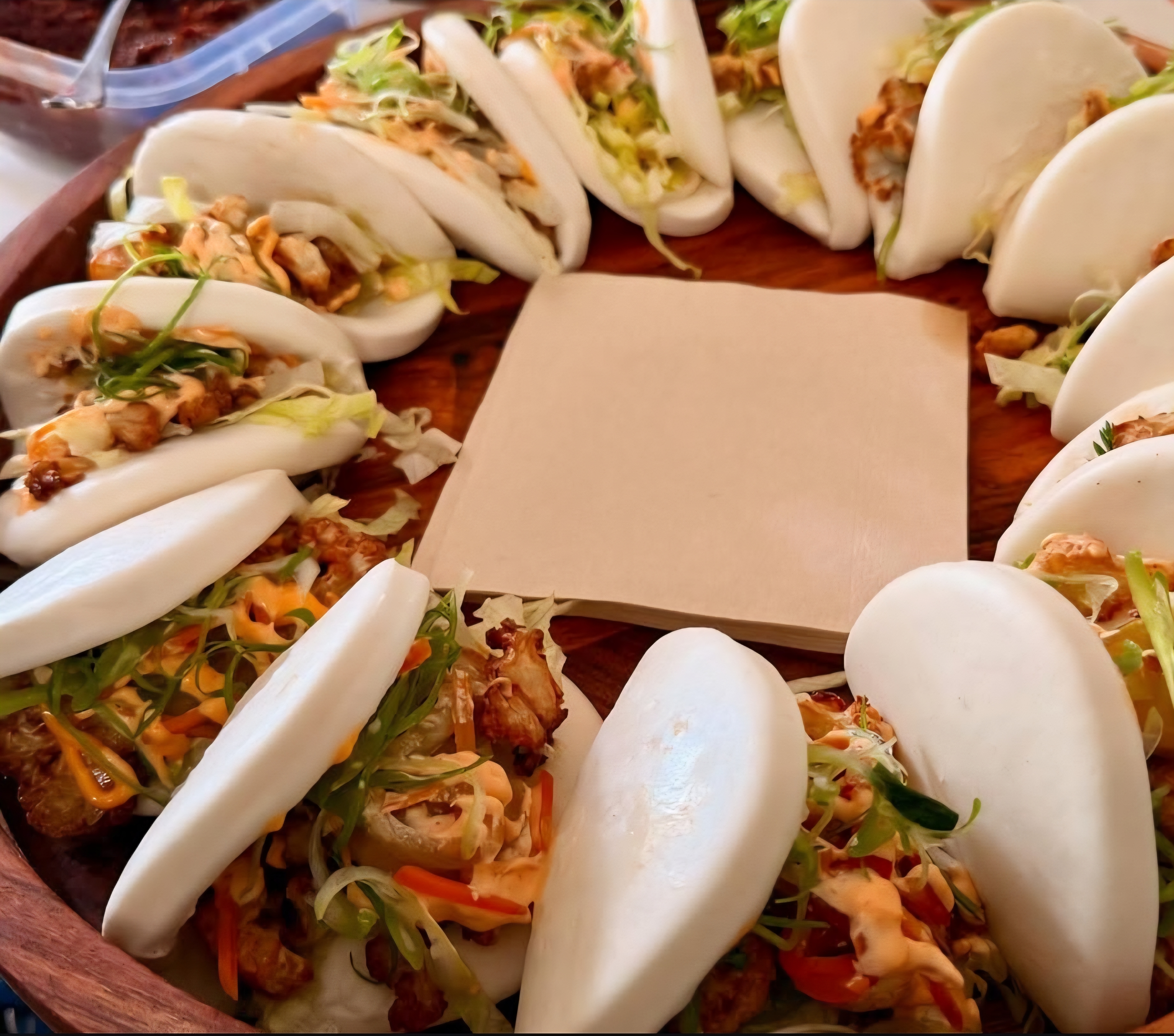 Bao buns arranged in a circle on wooden platter