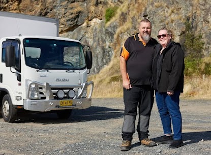 John and Leanne Cook with the Isuzu Pantech truck — owners of The Junk Removers & Pick Up Pros, Coffs Harbour